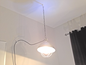 Brooder lamp hanging from ceiling by a chain